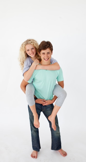 Young boy giving his girlfriend piggyback ride