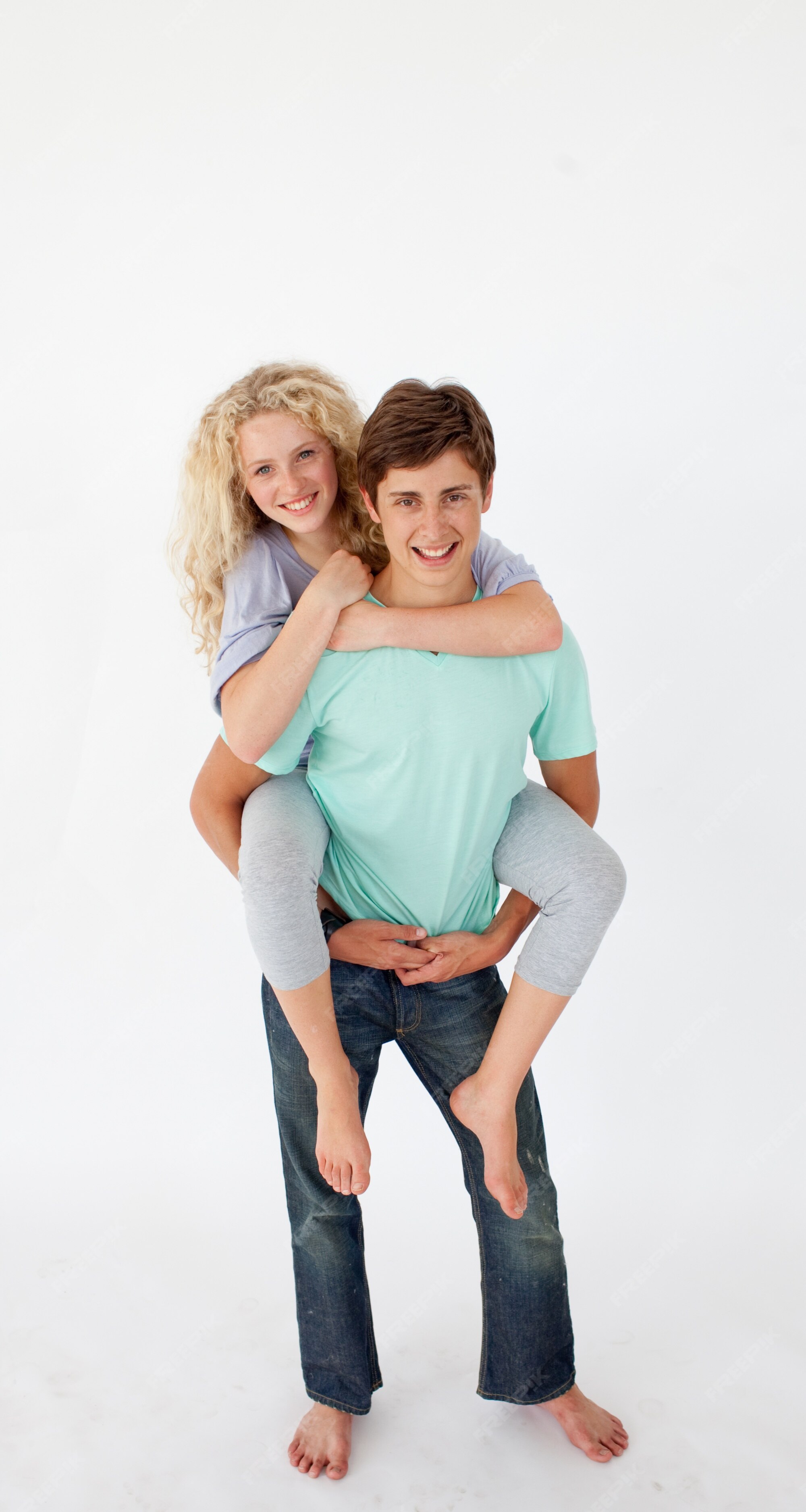 Teenage girl giving friend piggyback ride Stock Photo - Alamy