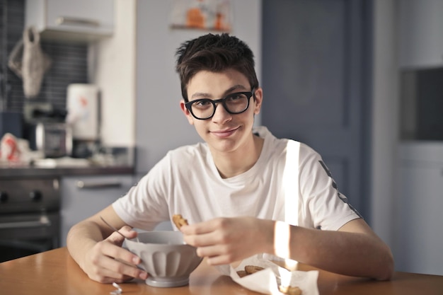 Young boy has breakfast with milk and cookies