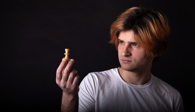 Young boy holding chess figure