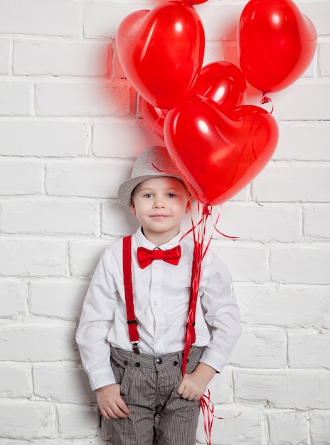 Young boy holding a heart-shaped ballon