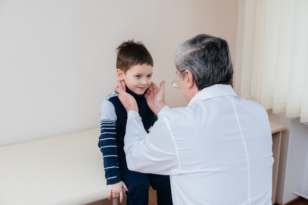 A young boy is listened to and treated by an experienced doctor in a modern clinic. A virus, and an epidemic