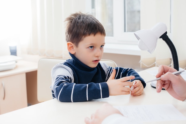 A young boy is listened to and treated by an experienced doctor in a modern clinic. A virus, and an epidemic