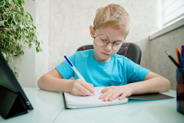 Young boy learn by tablet at home. Distance learning in quarantine.