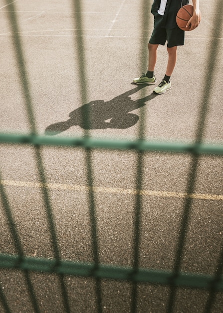 Young boy playing basketball at basketball court