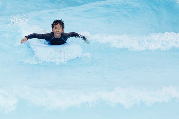 Young boy playing in clear water