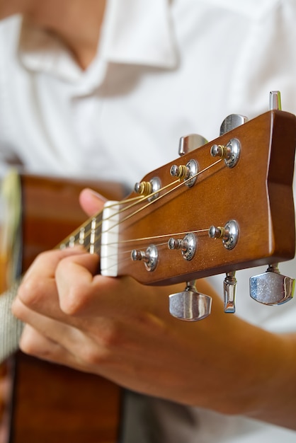 Young boy playing guitar.