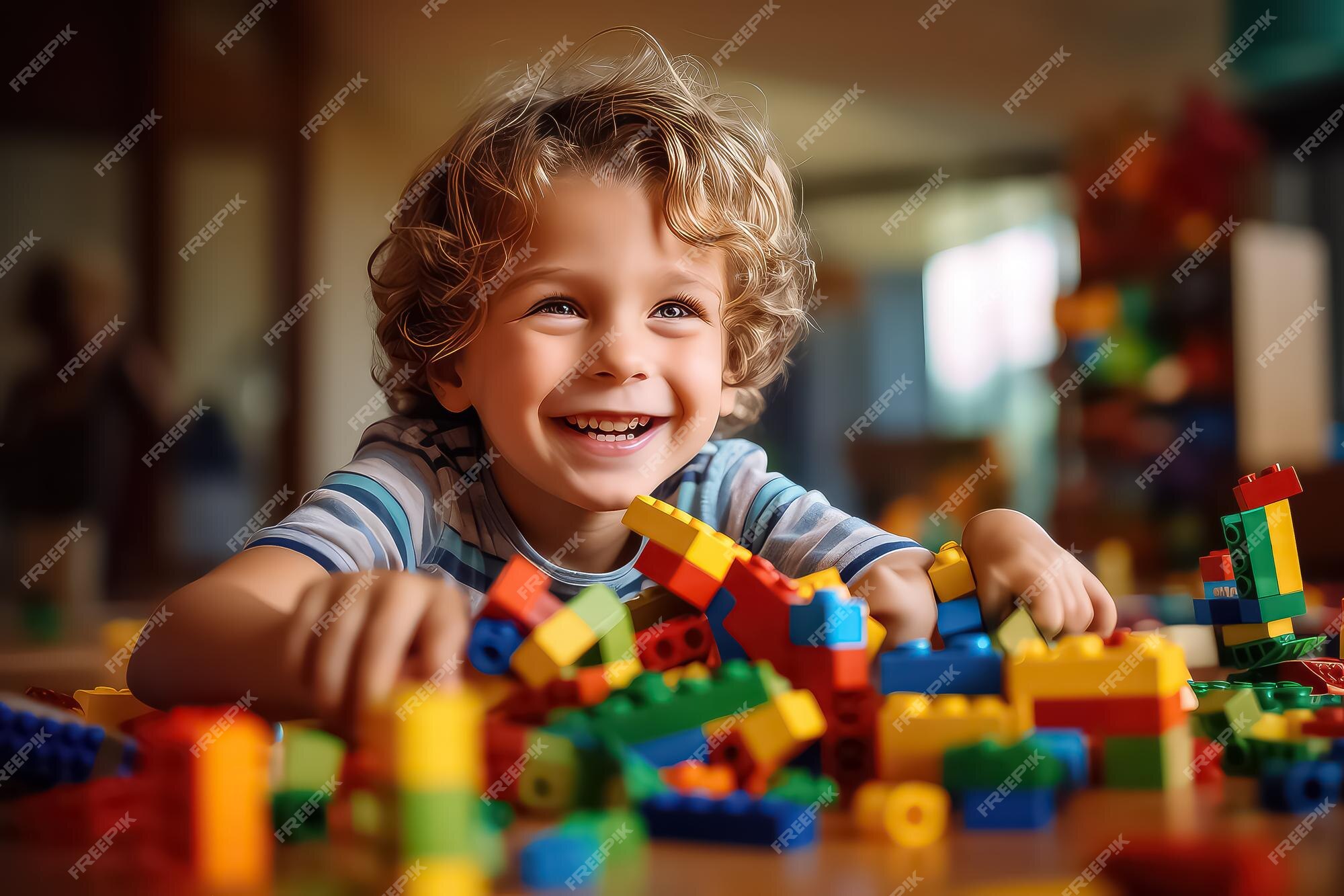 Premium AI Image Young Boy Playing With Lego Blocks While Smiling premium-ai-image-young-boy-playing-with-lego-blocks-while-smiling