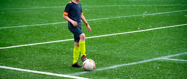 Young boy playng football soccer, healthy lifestyle with successful futures