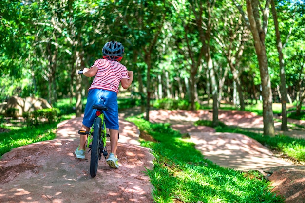 Young boy riding bikes in the garden