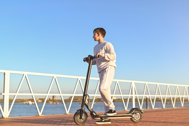Young boy riding an electric kick scooterteenage boy riding kick scooter in skatepark