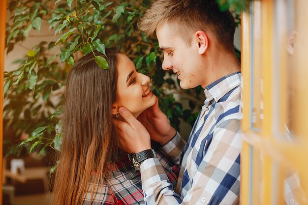 a young boy in a shirt in a cell standing in a cafe together with his girlfriend