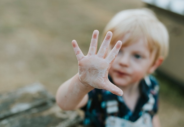 Young boy showing his dirty palm