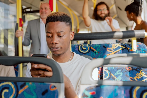 Young boy sits looking at phone sending text message