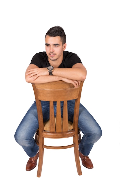 Young boy sitting on a chair on a white background