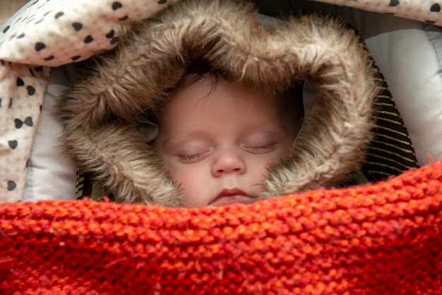 Young boy sleeping in the stroller