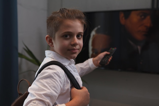 Young boy smiling to the camera switching tv channels