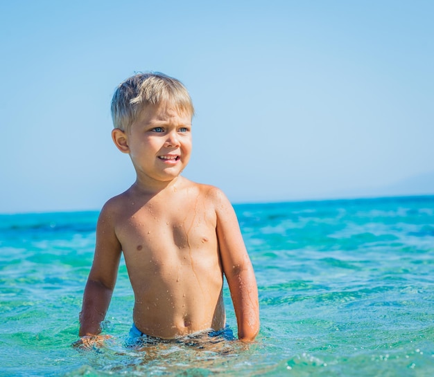 Young boy swimming in sea