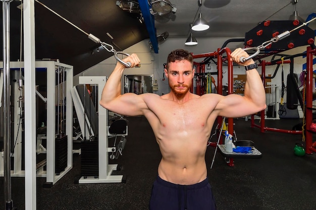 Young boy training his biceps in the gym