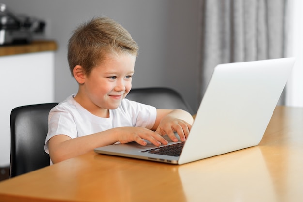 A young boy using a laptop