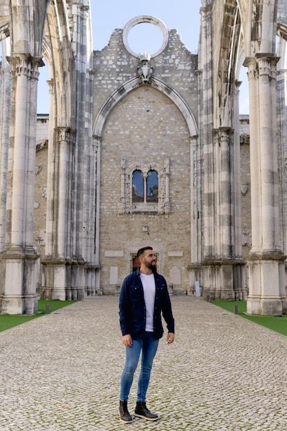 Young boy walking inside the Carmo Convent in Lisbon Portugal