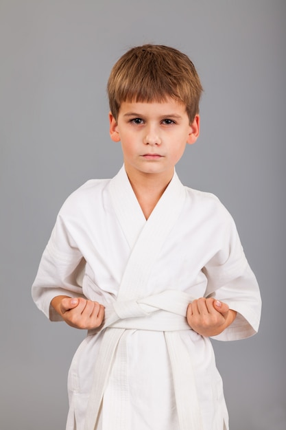 Young boy wearing white karate kimono