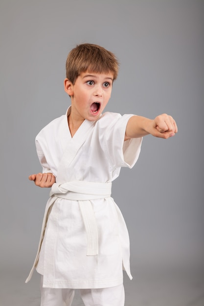 Young boy wearing white karate kimono