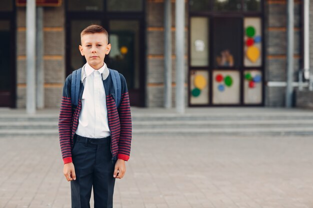 Young boy with backpack going back to school