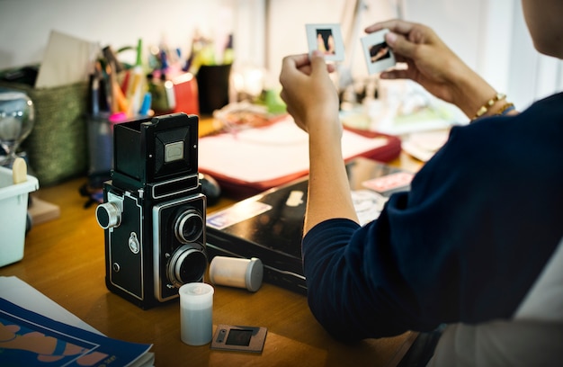 Young boy with camera and photos