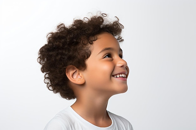 a young boy with curly hair smiling and looking up