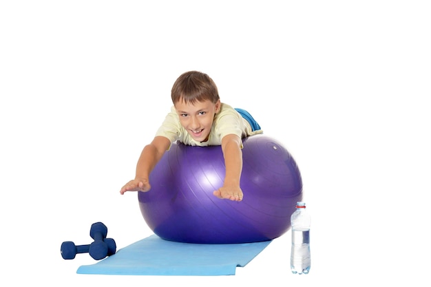 Young boy with fit ball and dumbbells