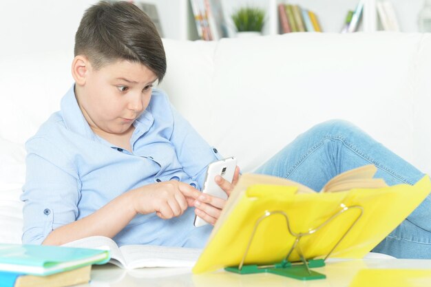 Young boy with smartphone playing the game