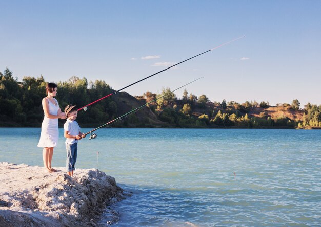 Young boy and women fishing on a lake