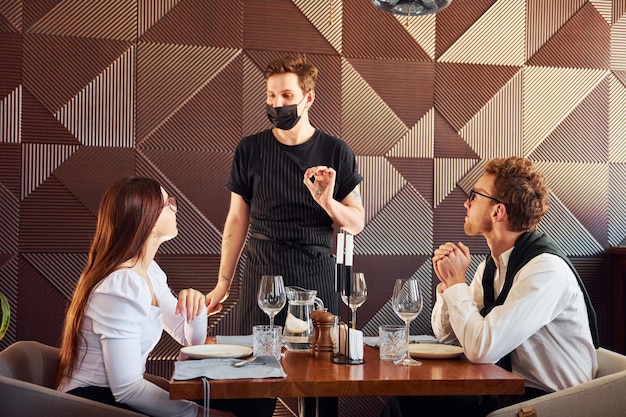 Young boyfriend with adult woman Indoors of new modern luxury restaurant