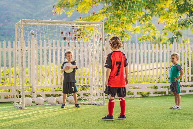 Young boys playing football soccer game running players in uniforms