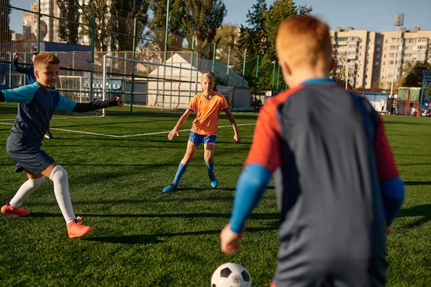 Young boys in sports soccer club on training unit improving skills