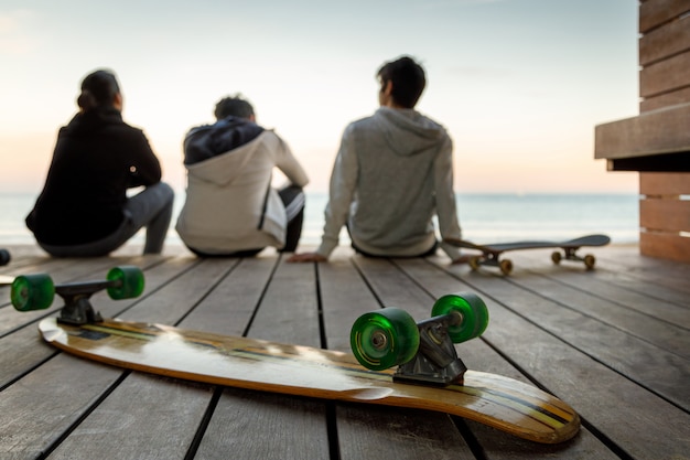 young boys watching the sunset on the beach