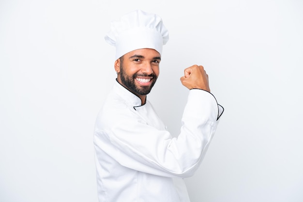 Young Brazilian chef man isolated on white background doing strong gesture