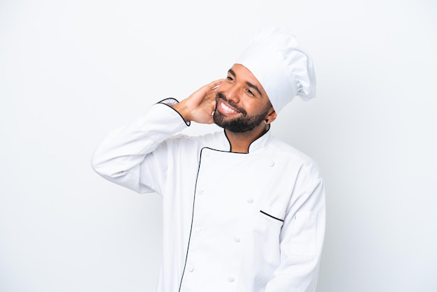 Young Brazilian chef man isolated on white background thinking an idea