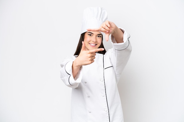 Young Brazilian chef woman isolated on white background focusing face Framing symbol