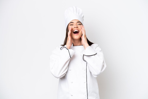 Young Brazilian chef woman isolated on white background shouting and announcing something