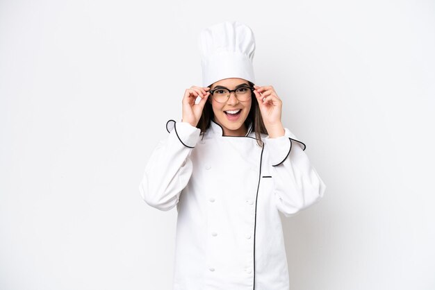 Young Brazilian chef woman isolated on white background with glasses and surprised