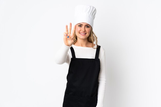 Young Brazilian chef woman isolated on white  happy and counting three with fingers