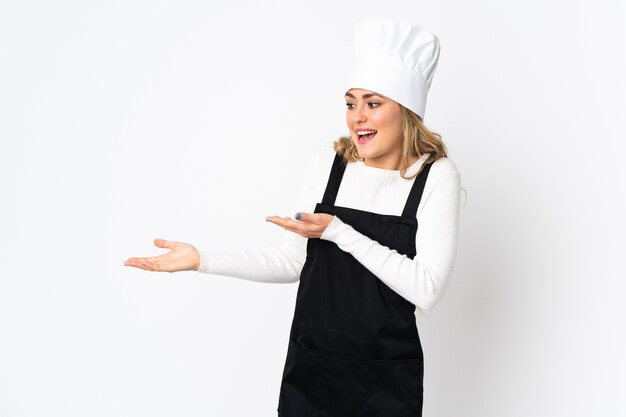 Young Brazilian chef woman isolated with surprise expression while looking side