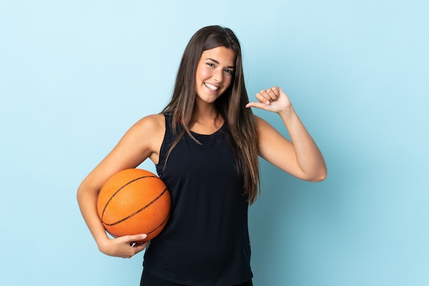 Young brazilian girl isolated playing basketball and proud of himself