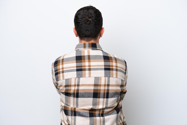 Young Brazilian man isolated on white background in back position