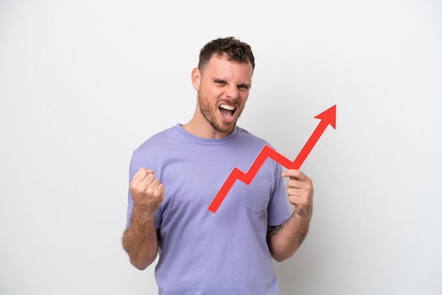 Young Brazilian man isolated on white background holding a catching a rising arrow and celebrating a victory