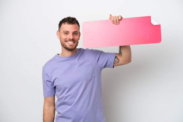 Young Brazilian man isolated on white background holding an empty placard