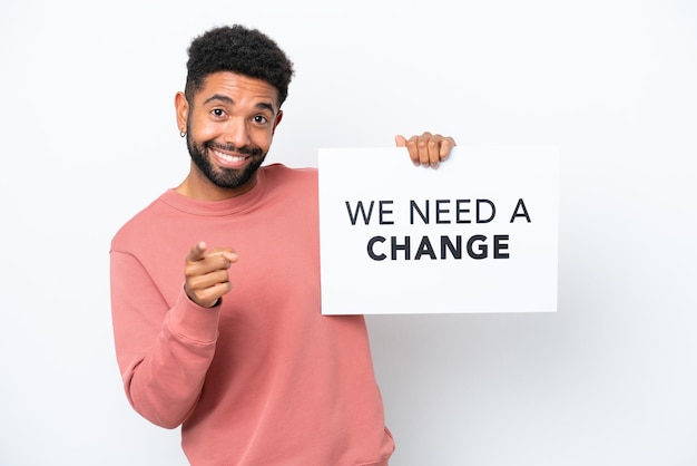 Young Brazilian man isolated on white background holding a placard