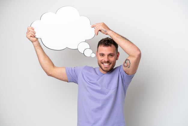 Young Brazilian man isolated on white background holding a thinking speech bubble